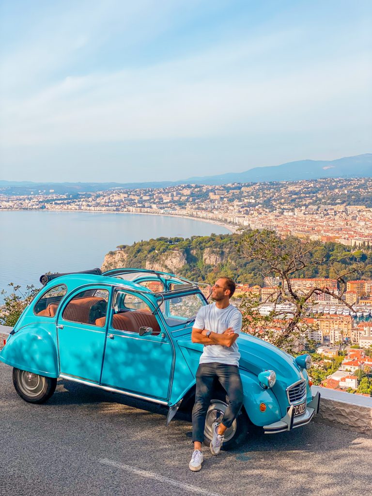 Man standing by a 2CV Citroën Car in Nice